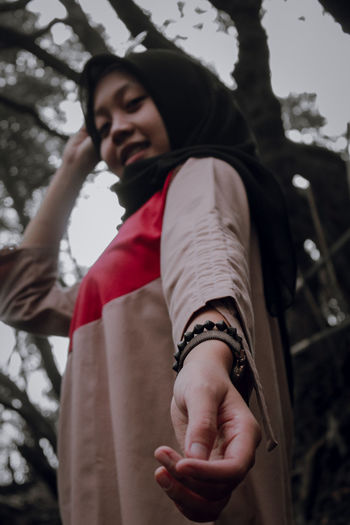 Low angle view of woman looking at camera