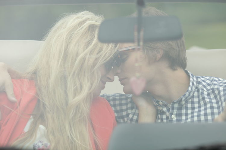 Young couple kissing in car