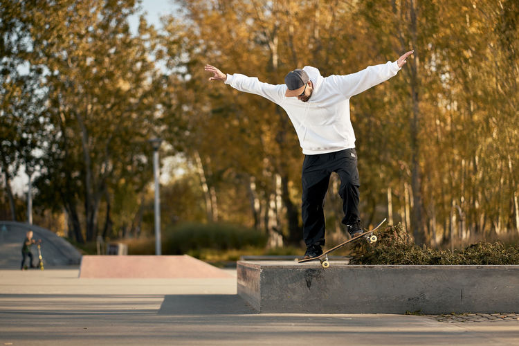 Full length of man skateboarding on skateboard park