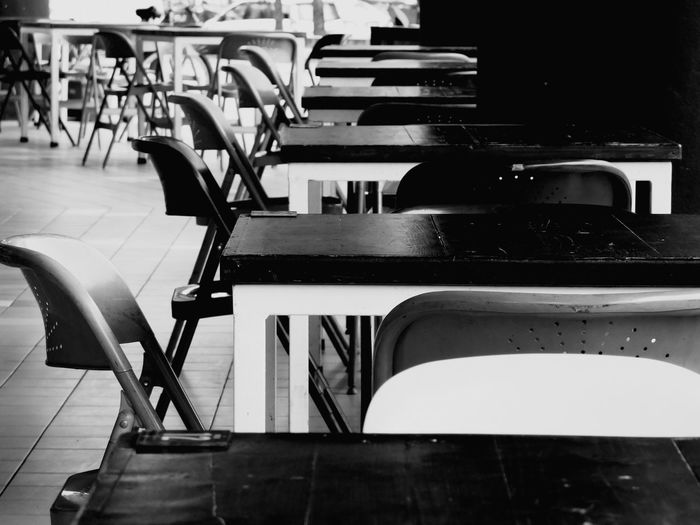 Empty chairs and tables in restaurant