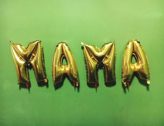 Mama text made with helium balloons against green background