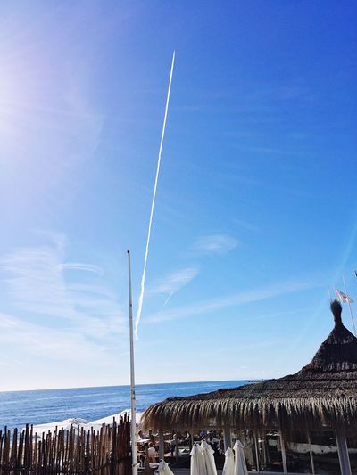 Low angle view of vapor trail over sea
