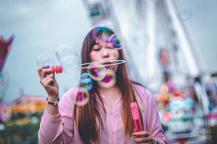 Portrait of beautiful woman with bubbles