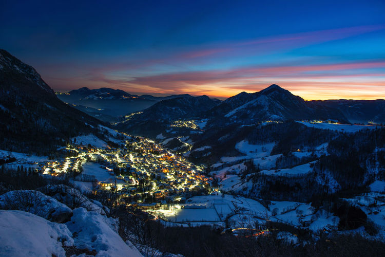 Snowy ski resort at sunset