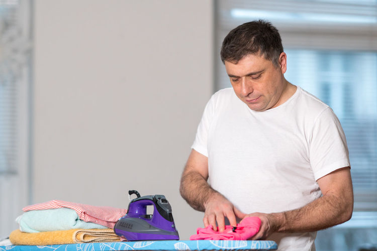 Man holding cloth at home