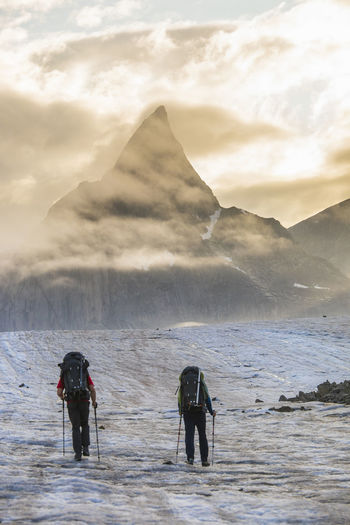 Two climbers en route to climb mount loki, baffin island.