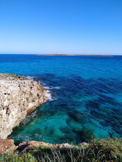 Scenic view of sea against clear blue sky