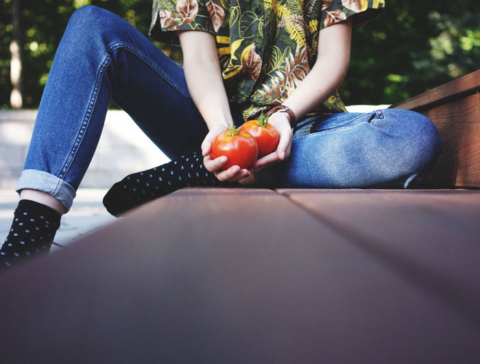 Person holding tomatoes