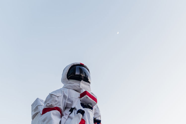 Low angle view of man standing against clear sky