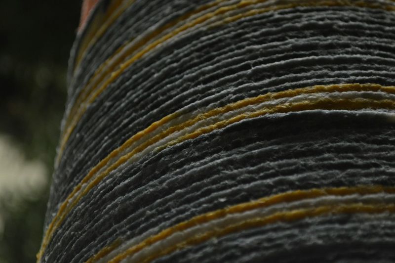 Close-up of yarn rolled on column