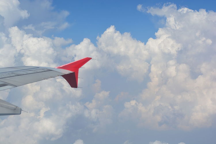 Low angle view of airplane wing against sky