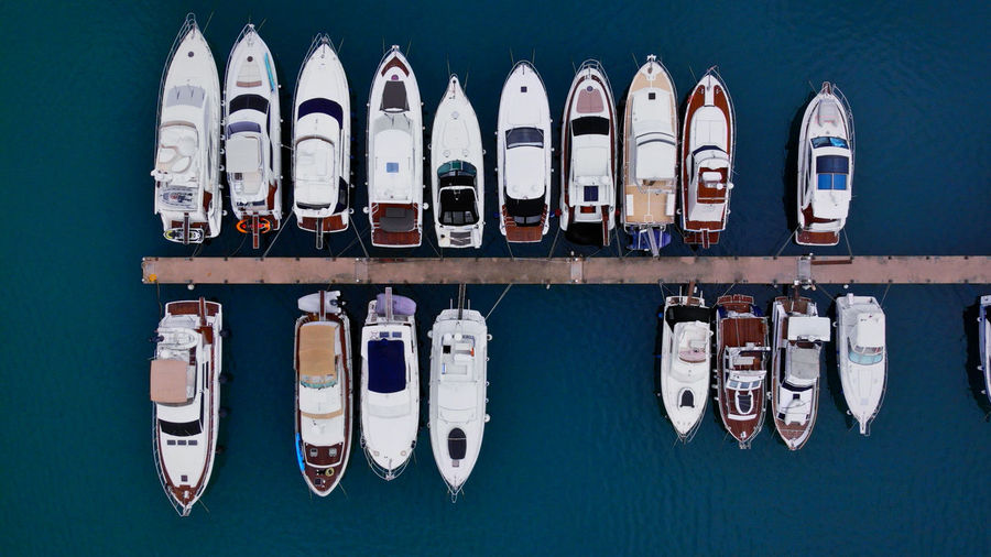 Aerial view of sailboats moored in row