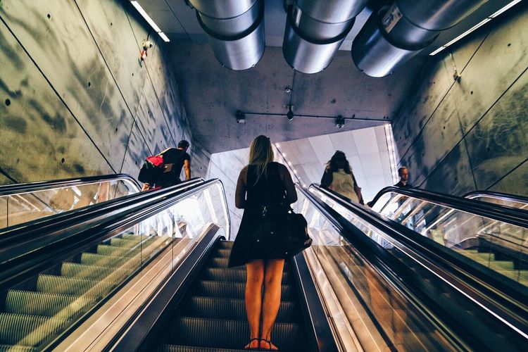 Low angle view of people on escalator