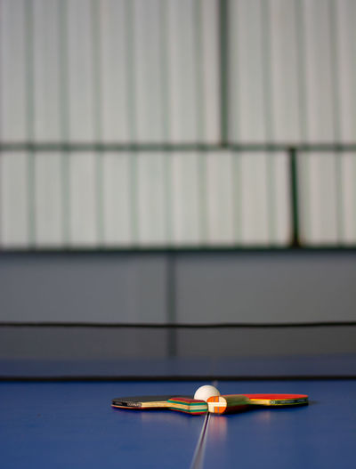 Close-up of a table tennis equipment against wall