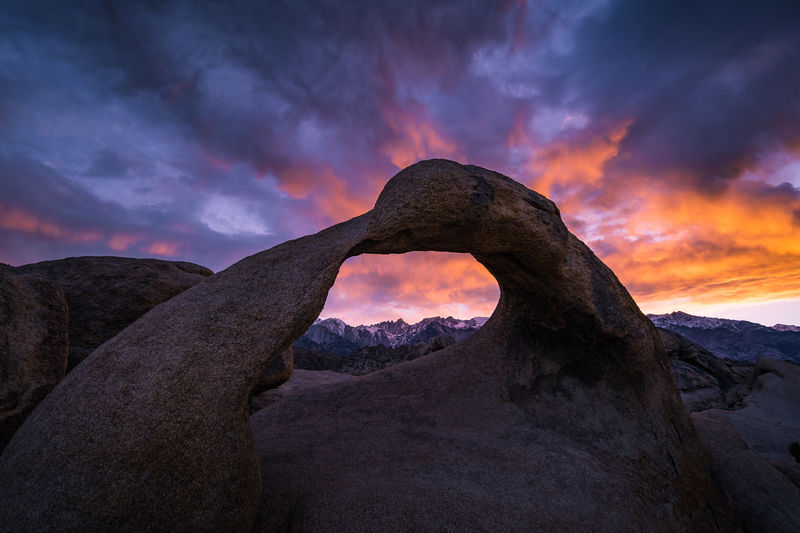 Scenic view of rock against sky during sunset