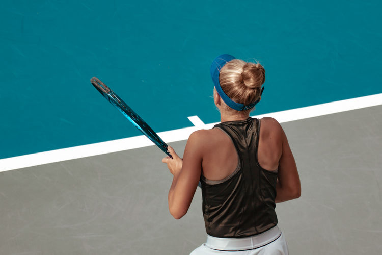 Tennis player playing tennis at court