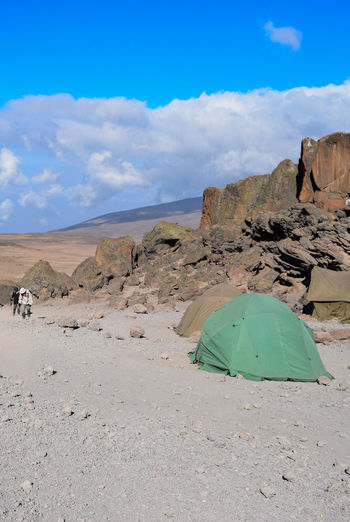 A group of hikers camping against scenic mountain landscapes at mount kilimanjaro 