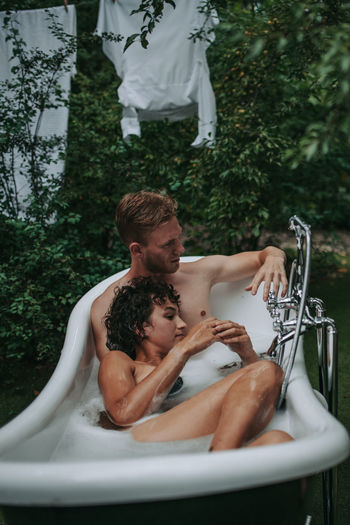 Couple in bathtub outdoors