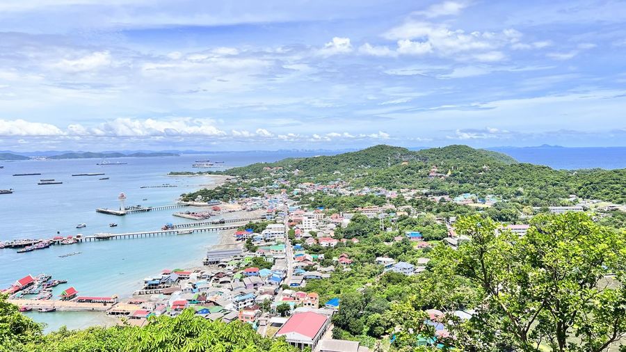High angle view of townscape by sea against sky