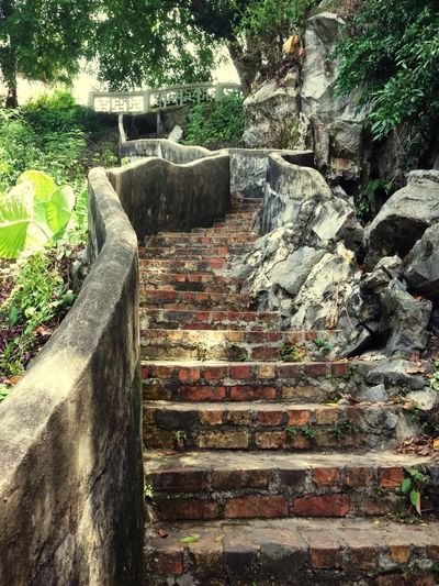 Staircase leading to stone wall