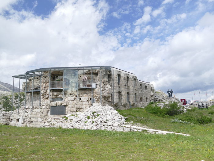 Old ruin building on field against sky
