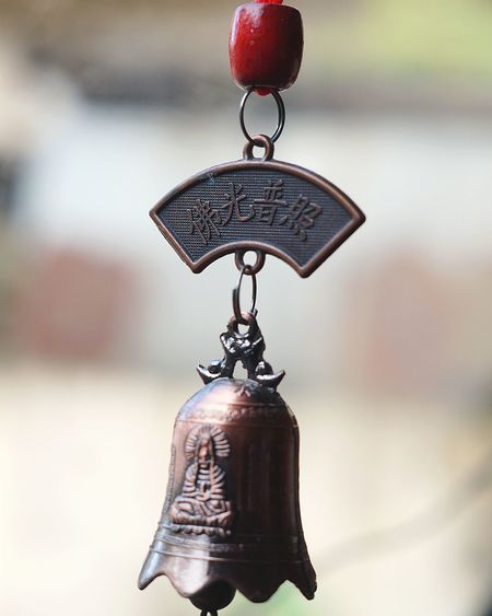 Close-up of hanging holy bell