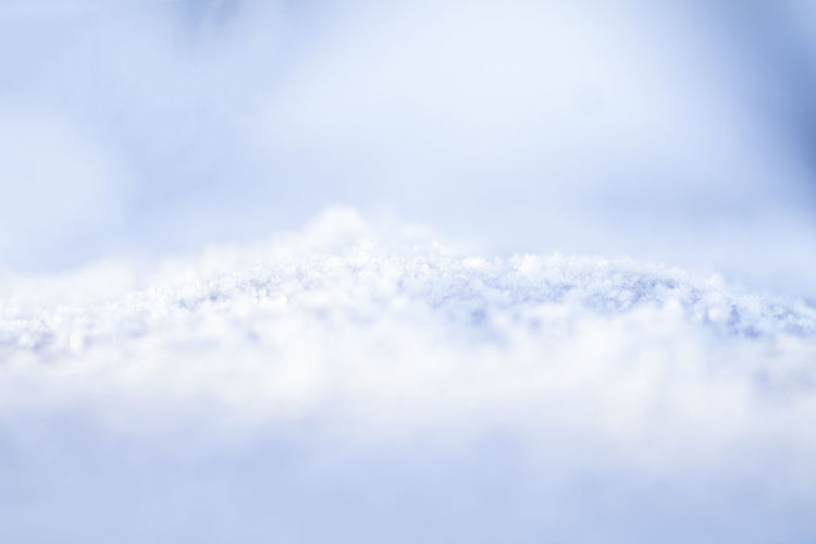 Close-up of snow against blue sky