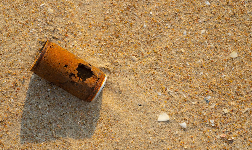 High angle view of cigarette on sand