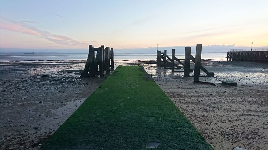 Scenic view of beach against sky during sunset