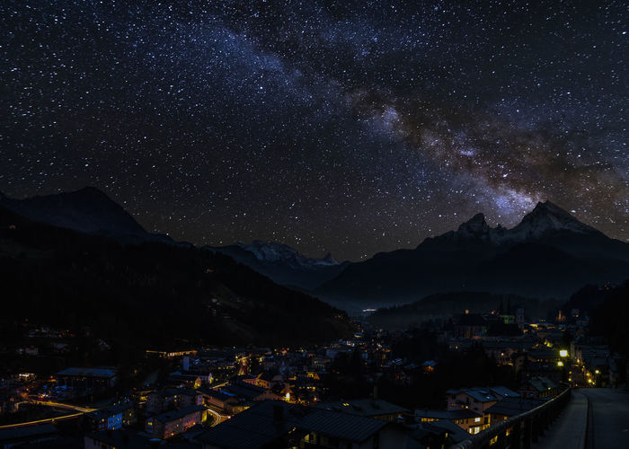 Illuminated mountains against sky at night