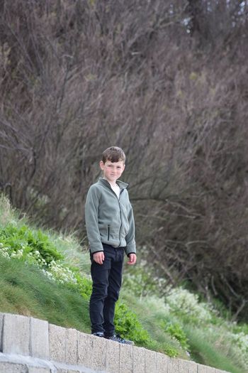 Portrait of boy standing on field