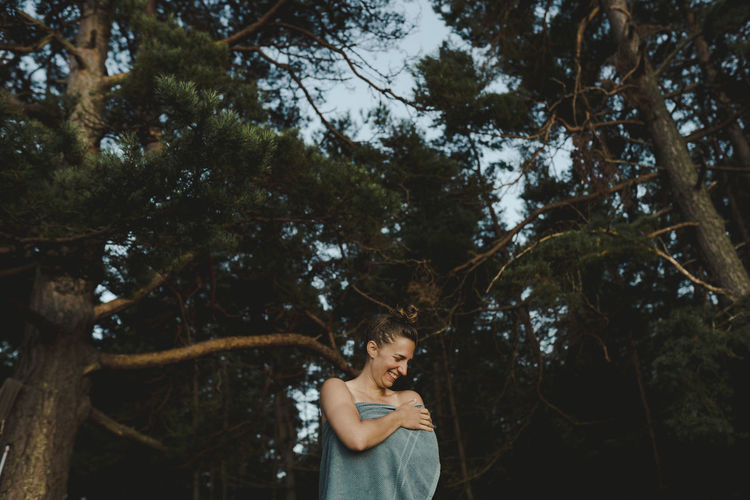Smiling woman wrapped in towel