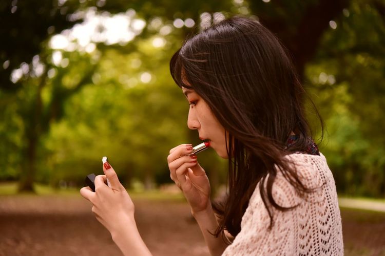 Portrait of a young woman smoking outdoors