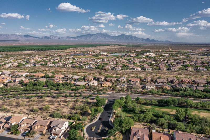 Residential complex with new houses and mountains in background, arizona. aerial view.
