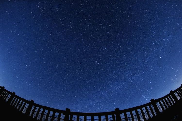 Low angle view of stars against blue sky