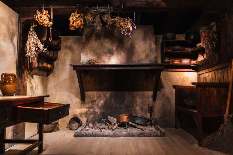 Old 19th century rustic kitchen with fireplace