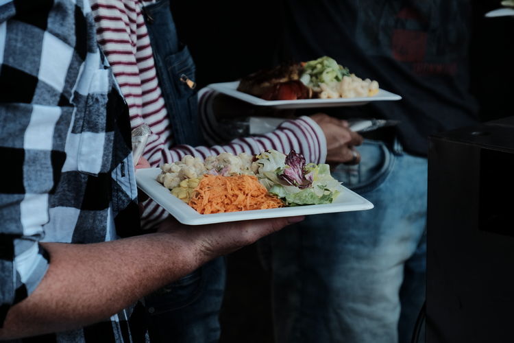 Midsection of people having food