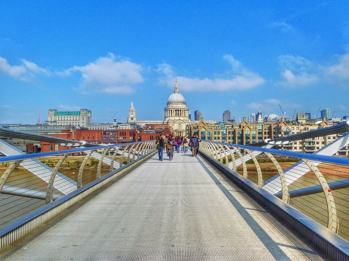 People walking on london millennium footbridge in front of st paul cathedral