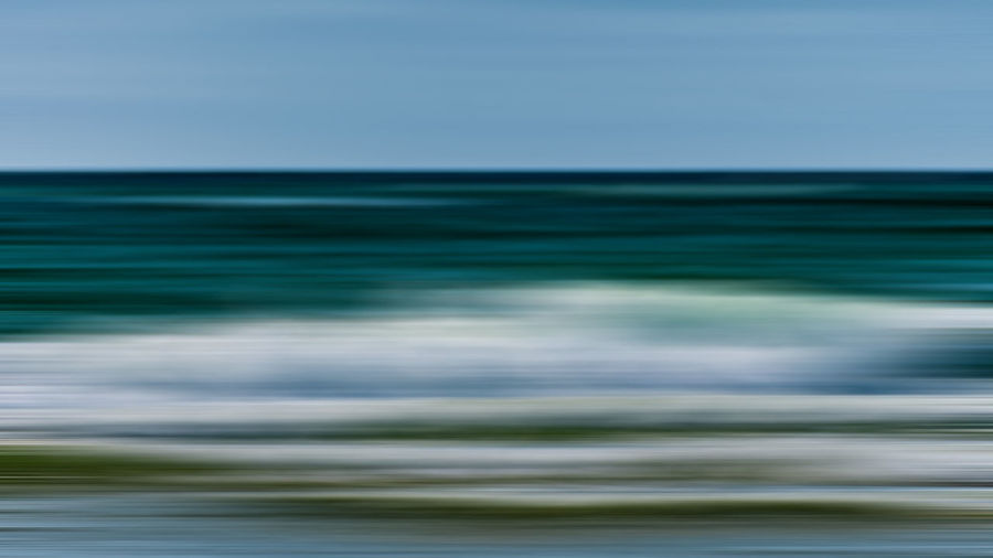 Blurred motion of sea against clear sky