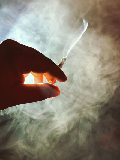 Cropped hand of person holding sparkler