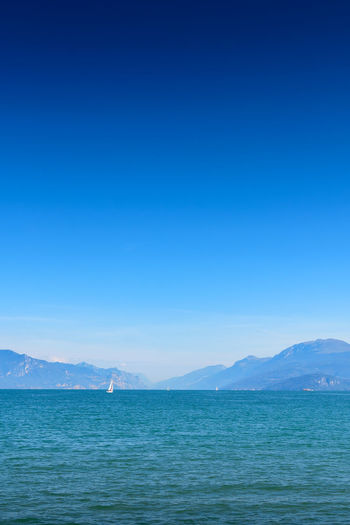 Scenic view of sea against clear blue sky
