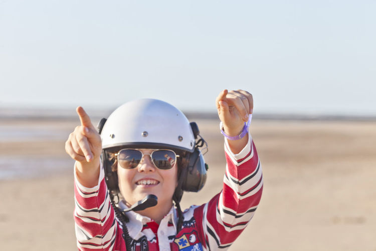 Portrait of woman wearing helmet and sunglasses outdoors